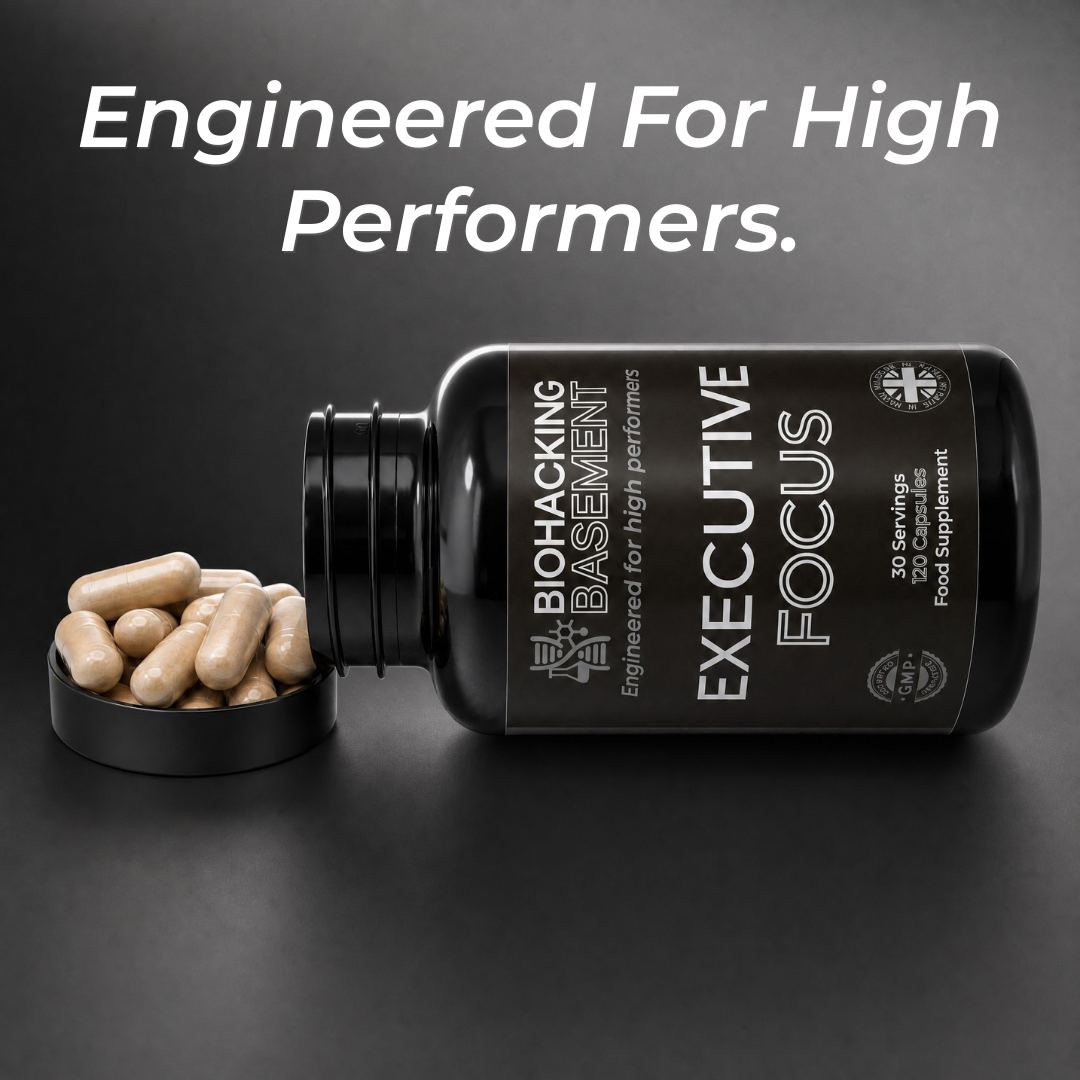 A black supplement bottle labeled 'BIOHACKING BASEMENT EXECUTIVE FOCUS' lies on a dark surface with several beige capsules spilled into a small black dish beside it. Large white text at the top reads 'Engineered For High Performers.