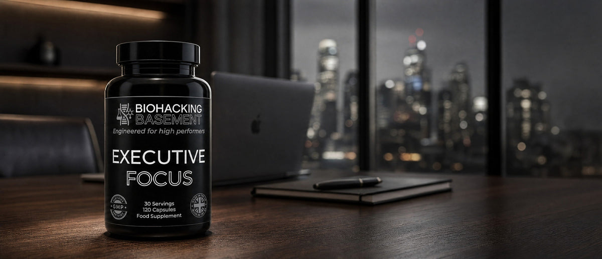 A black supplement bottle labeled 'BIOHACKING PREMIER Executive Focus' sits on a dark wooden desk in front of a blurred office window showing a city skyline at night.