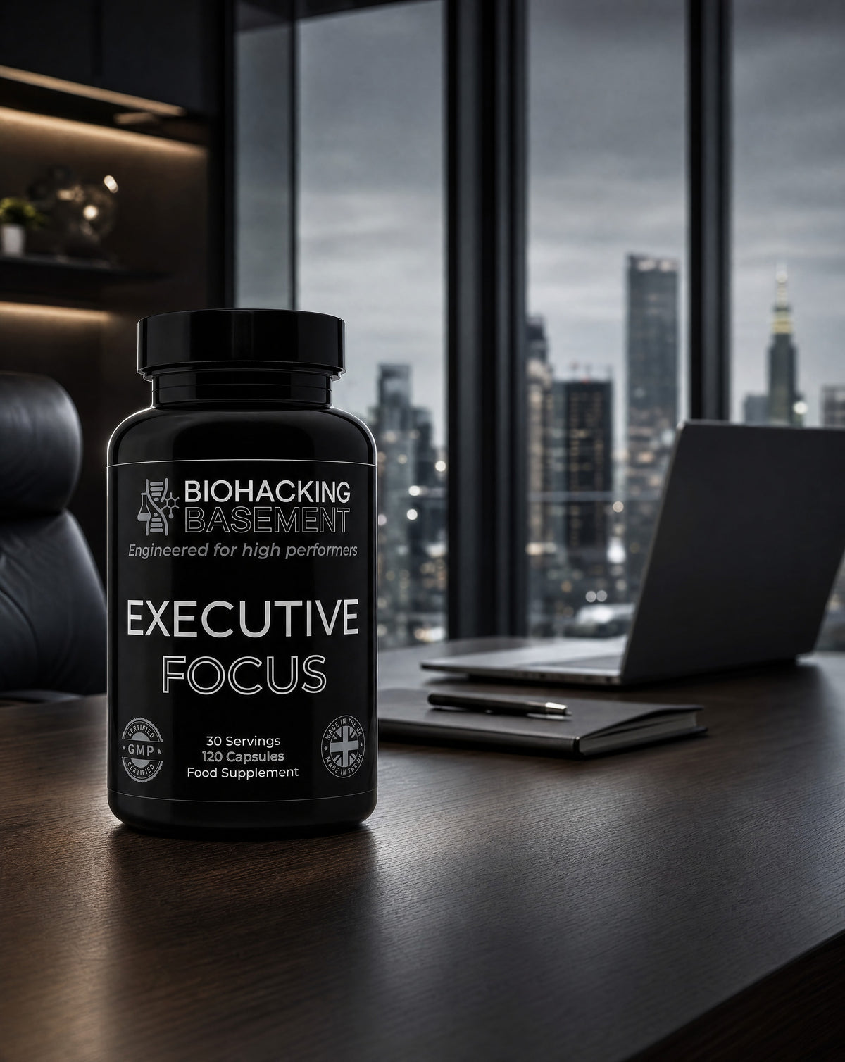 A black bottle of Executive Focus food supplement by Biohacking by Basement, placed on a dark wooden desk in a modern office setting with a laptop and city view in the background.